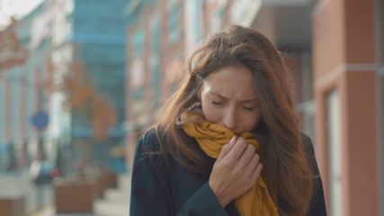 Face young woman stand sneezing coughs feel sick at outdoor fever cold allergy city beautiful disease female nose lady runny tissue air pollution adult illness district slow motion