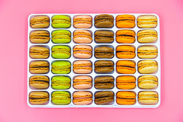 Tasty Macaroon cookies closeup on pink Background. Assortment Almond Dessert macaroni. 