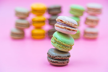 Tasty Macaroon cookies closeup on pink Background. Assortment Almond Dessert macaroni. 