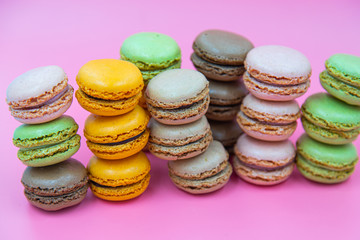 Tasty Macaroon cookies closeup on pink Background. Assortment Almond Dessert macaroni. 