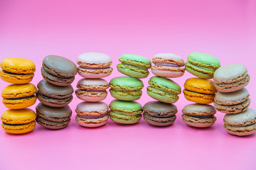 Tasty Macaroon cookies closeup on pink Background. Assortment Almond Dessert macaroni. 