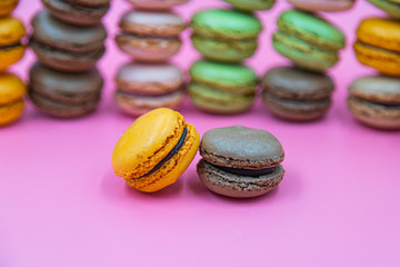 Tasty Macaroon cookies closeup on pink Background. Assortment Almond Dessert macaroni. 
