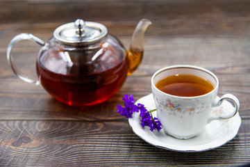 Cup of tea with macaroons on pink background