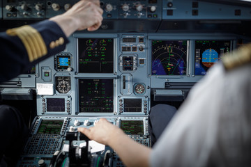 Pilot's hand accelerating on the throttle in  a commercial airliner airplane flight cockpit during...