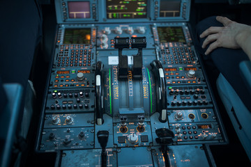 Pilot's hand dialing in flight values in  a commercial airliner airplane flight cockpit during...