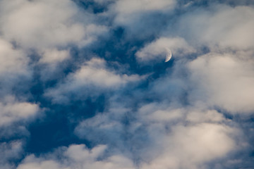 Fototapeta na wymiar Mystical moon in the evening sky surrounded by dramatic clouds