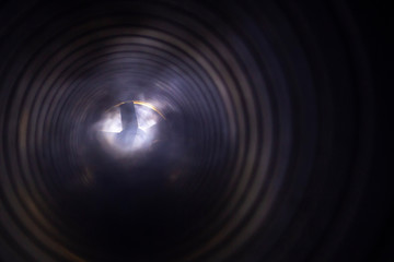 smoke and fire inside the air duct in the ventilation system, the front and back background is blurred with a bokeh effect