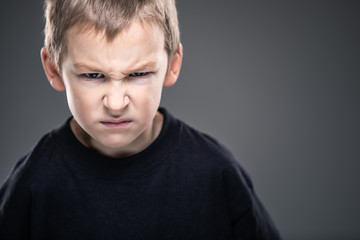 Loads of aggression in a little boy - education concept hinting behavioral problems in young children (shallow DOF)