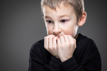 Anxiety/fear in a little boy - education concept hinting behavioral problems in young children (shallow DOF) - anxious/scared expression, biting his fingers