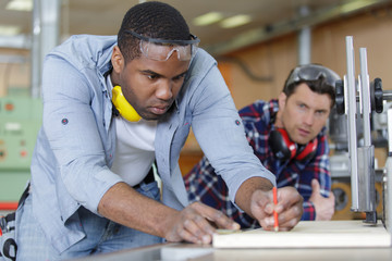 man with apprentice in workshop