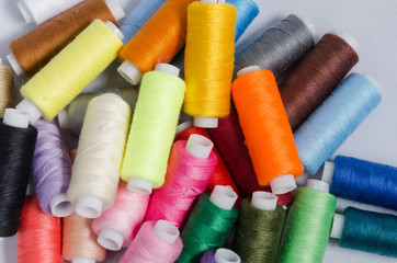 sewing threads different colors, very colorful in background, colorful background