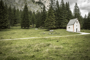 An isolated little chapel (St. Silvester) among the woods in the Italian Dolomites