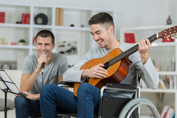 the handicapped guitarist with a friend