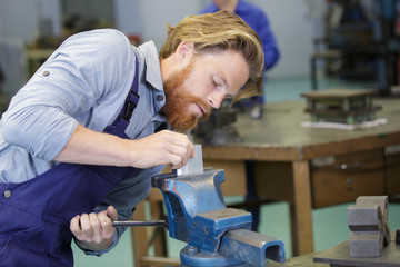 worker tighten the nut of the tool holder