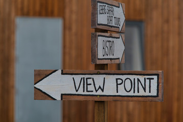 Old wooden viewpoint sign on a tourist trail