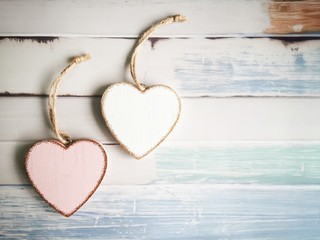 Valentine's Day. Two hearts on a wooden background. 