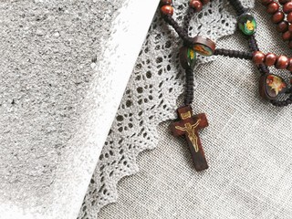 Old rosary and ash - symbols of Ash Wednesday. Canvas background. Top view. 