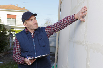 construction manager touching the wall