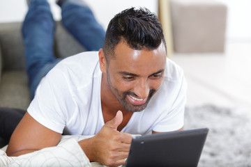 portrait of man with laptop on sofa