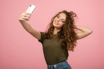 Closeup studio portrait of pretty student with smartphone