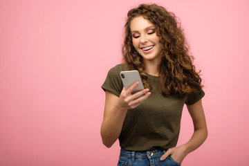 Closeup studio portrait of pretty student with smartphone