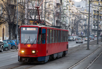 Fototapeta na wymiar Vibrant red tramway in city