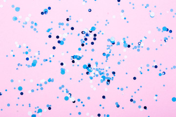 Falling confetti on bright background. Holiday and party concept.