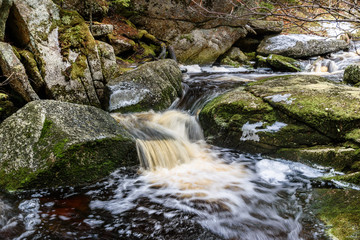 Brook Falls in deep forest with rocks and moss