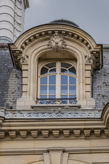 Old French house with traditional balconies and windows. Paris, France.