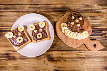 Two sandwiches with chocolate spread on a plate. Sandwich like a bear muzzle. Top view