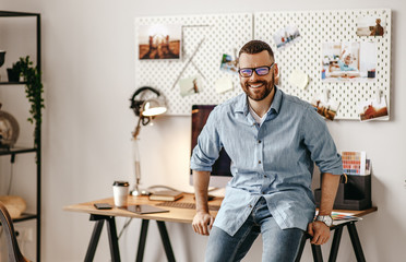 young handsome business man freelancer working at home on computer.
