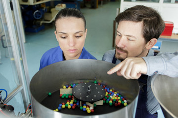 workman and woman working in factory