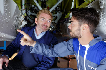 portrait of workers talking about airplane