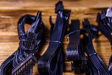 Fototapeta na wymiar Set of computer psu cables on a wooden background