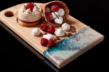 Exclusive painted art cutting board made of wood organic serving dishes with taste food cuisine waffles with sweet candy cream raspberry berry ice sugar cake waffle.