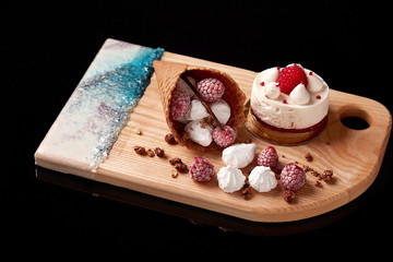 Exclusive painted art cutting board made of wood organic serving dishes with taste food cuisine waffles with sweet candy cream raspberry berry ice sugar cake waffle.