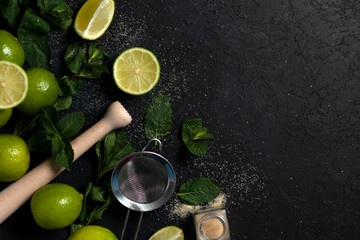 ingredients for making mojito on a dark background, lime, mint, with tools, flat lay for a mojito recipe