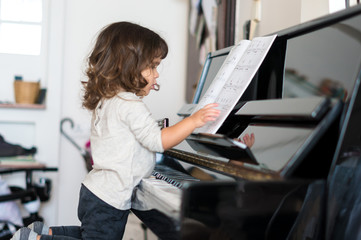 Side View Of Girl Learning Piano