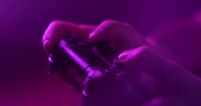 Man hands holding joystick gamepad for playing video games, professional cyber sports athlete champion play and win game