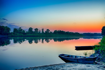 Tranquil and Peaceful Picturesque Landscape of The Pripyat River with Wooden Boat at Foreground. Lake is a Part of National Polessie Reserve.