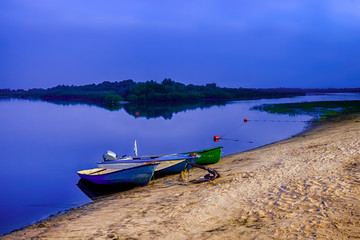 Motorboats Moored at Sandy Shore of The Peaceful Pripyat River. River is a Part of National Rivers Reserve.