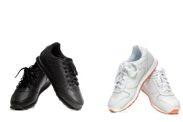 Two Pairs of New Black and White Modern Sport Trainers Placed over Over White Background.