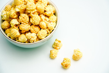 A bowl of caramel and cream flavored popcorn snack. A bowl of popcorn