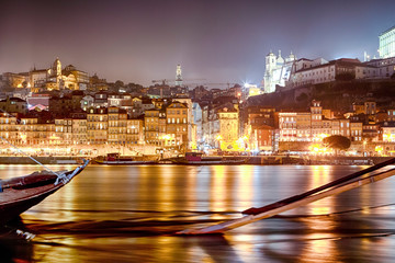 On Douro River in Porto in Portugal At Dusk with Line of Wooden Boats.