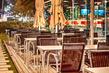 Wicker Chairs in One of The Caffees of Porto City in Portugal At Dusk.