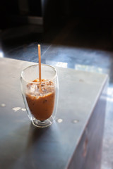 Iced coffee in coffee shop on wooden table