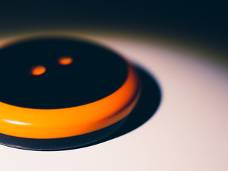Orange and black button