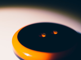 Black and orange button