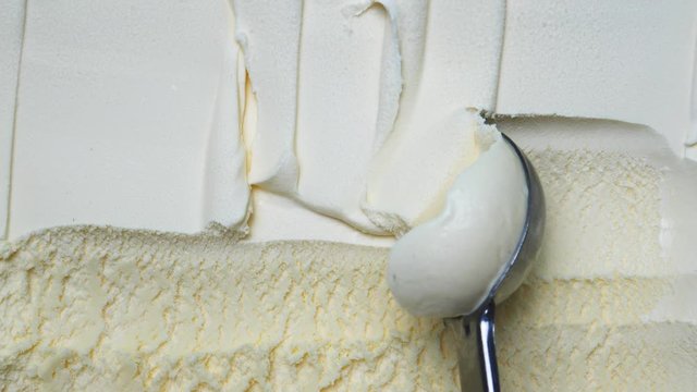 Closeup scooping Ice cream flavoured Coconut out from container with a spoon, Blank for design Food concept.