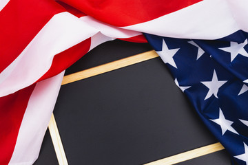 Fototapeta premium US American flag with blackboard on blue background. For USA Memorial day, Presidents day, Veterans day, Labor day, Independence day, or 4th of July celebration. Top view, copy space for text.